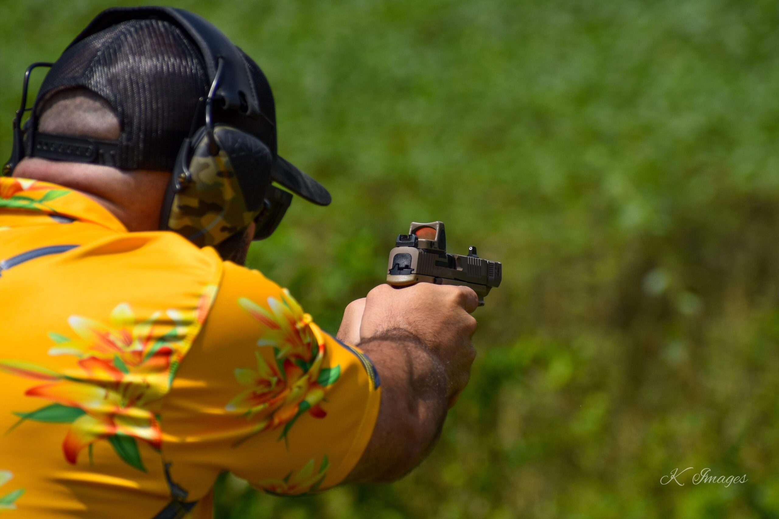 Shooter practicing handgun marksmanship with a red dot sight during live-fire training in Fallston, Maryland.