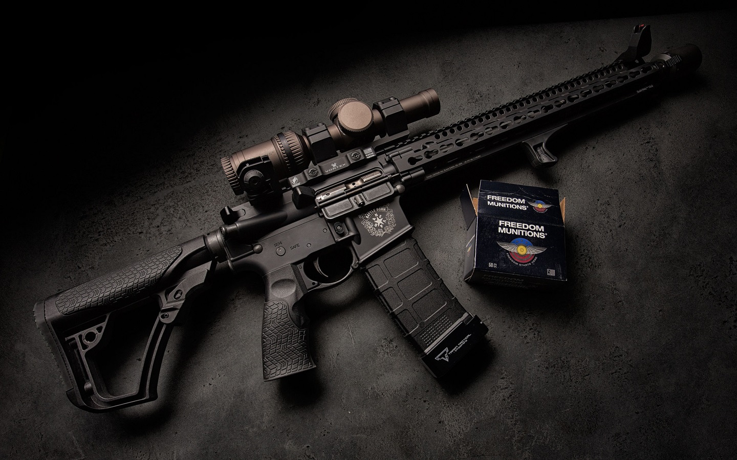 Daniel Defense rifle with accessories displayed on dark background