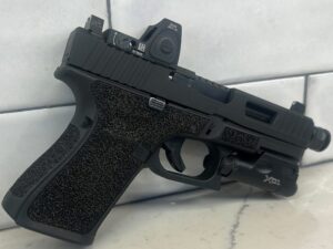 Custom Glock Stippling and Frame work displayed on tile surface.